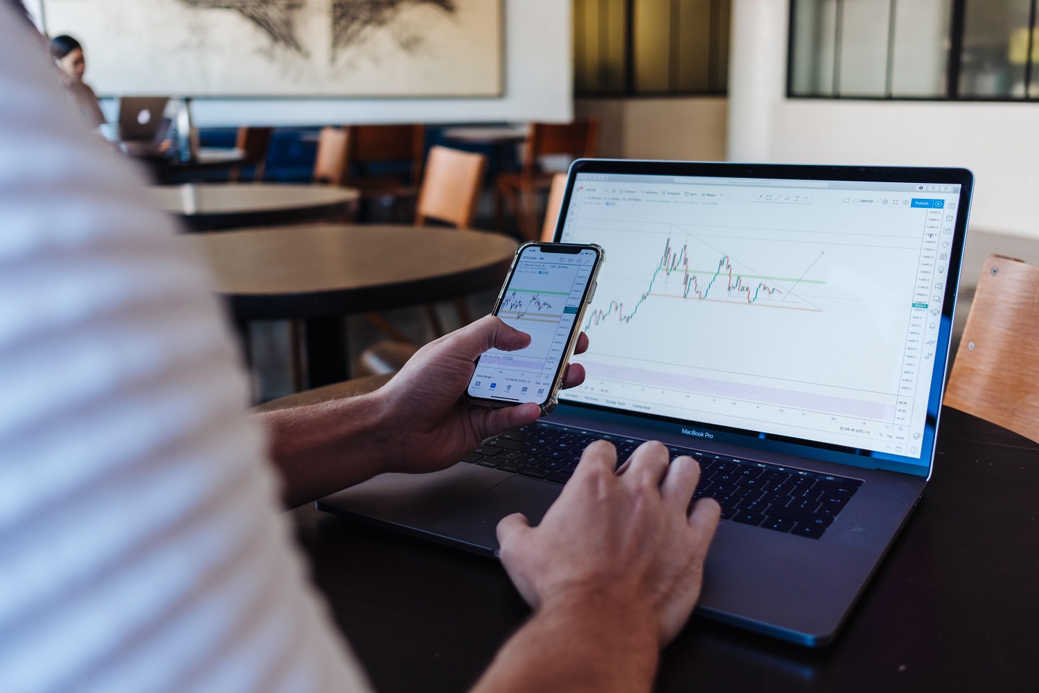 A laptop computer and phone showing line graphs.