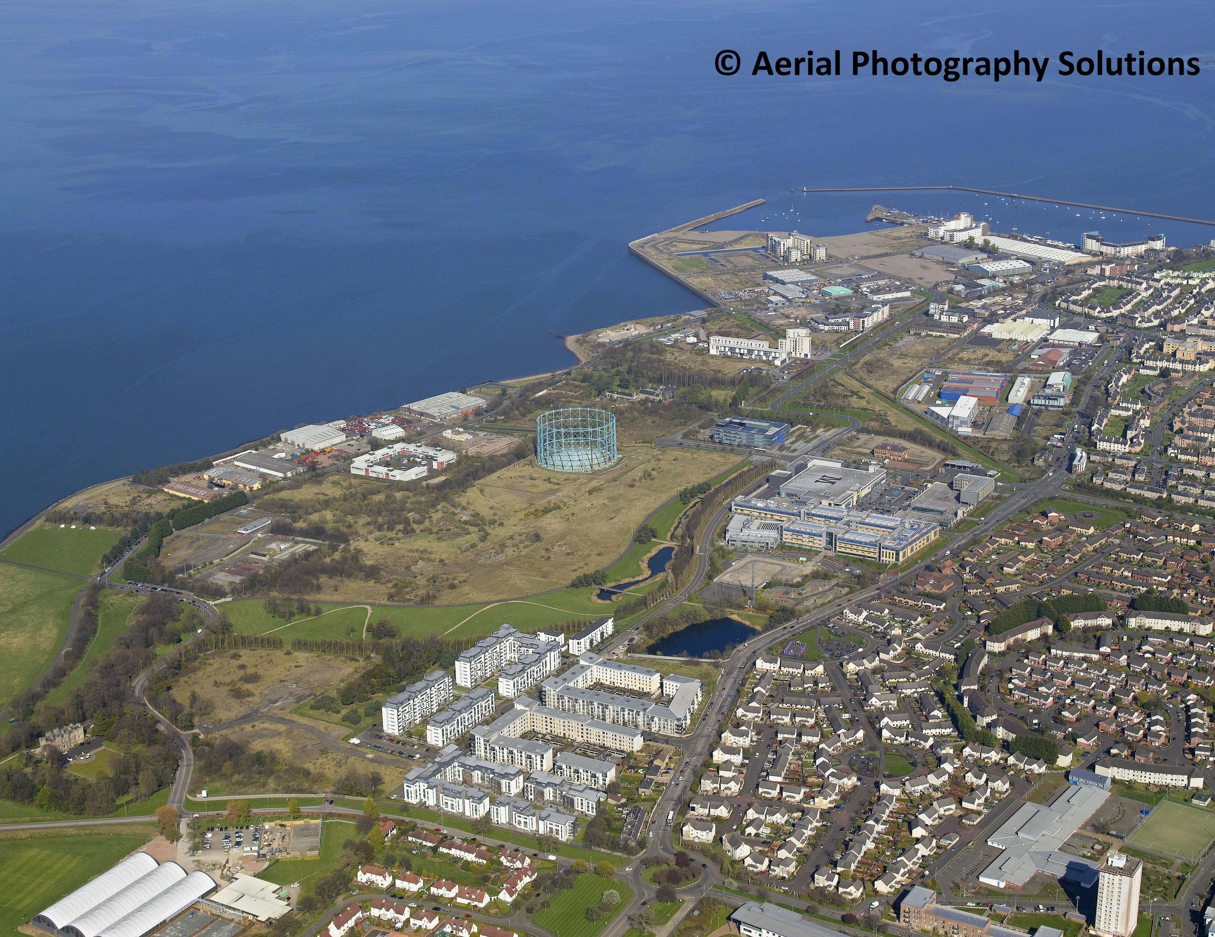 An aerial photograph of land and buildings near a river estuary.