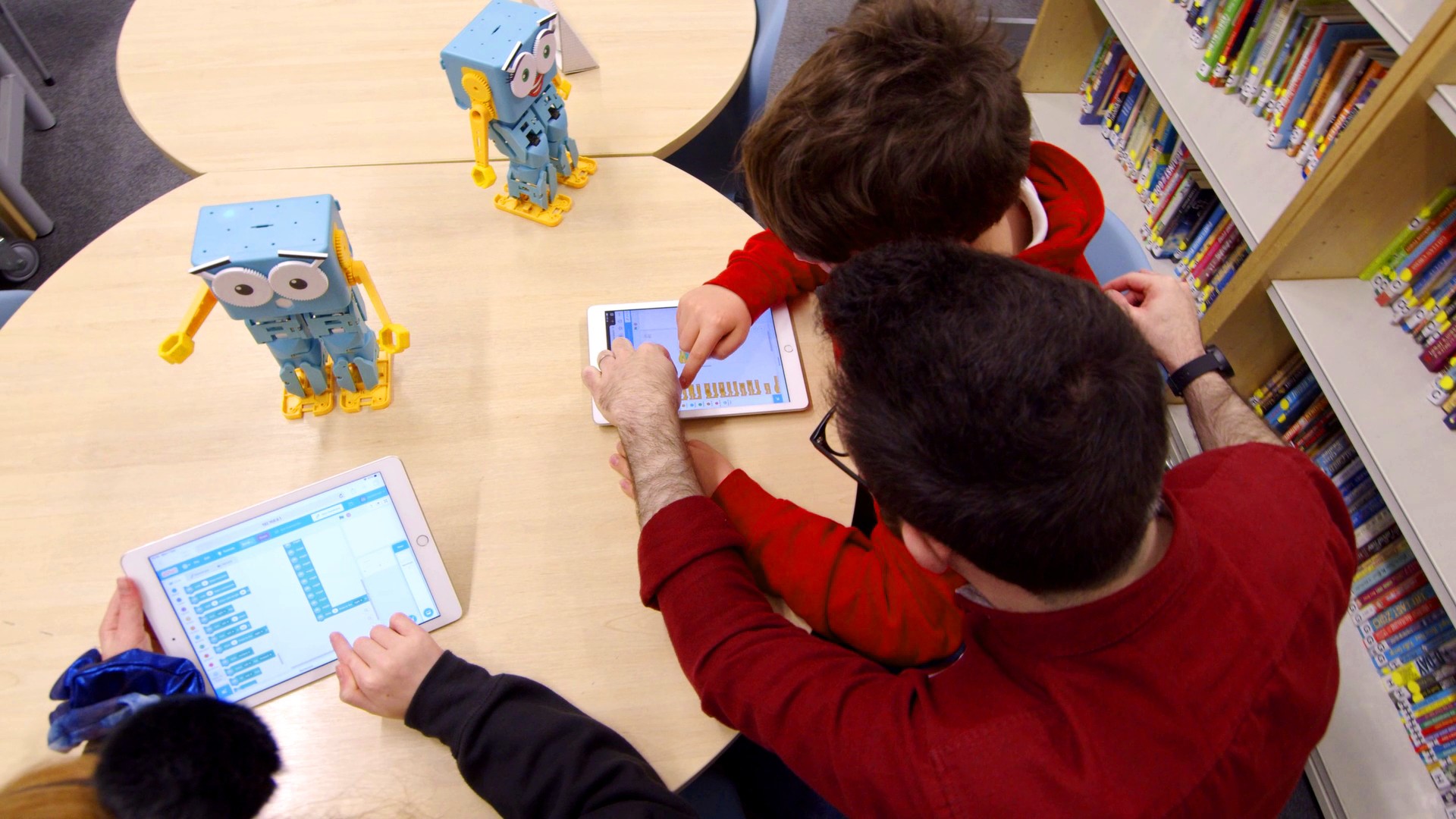 A photograph of students learning about robotics.