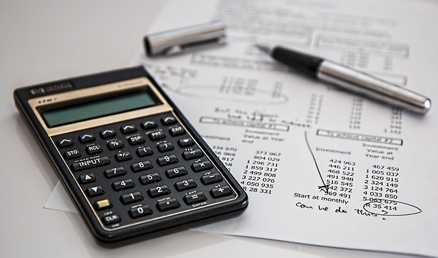 A calculator and financial paperwork.